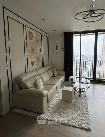 Modern living room with stylish decor and city view from large windows.