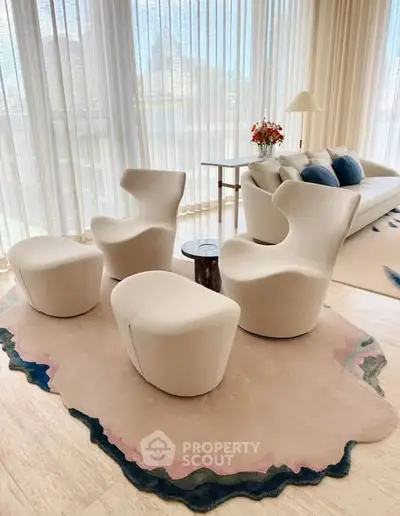 Elegant modern living room with stylish furniture and large windows offering natural light.