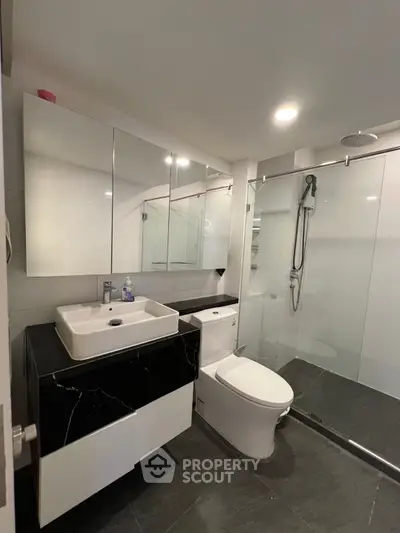 Modern bathroom with sleek fixtures and glass shower enclosure