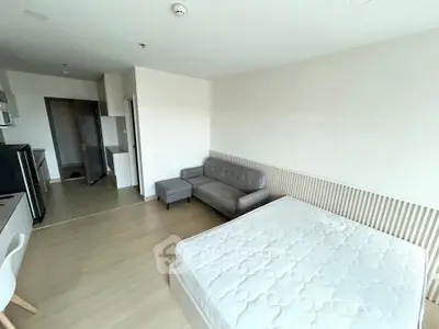 Modern studio apartment with cozy living area and kitchen