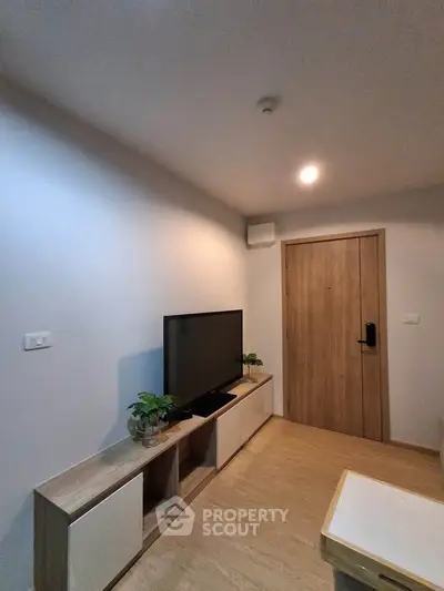 Modern living room with sleek TV stand and wooden flooring