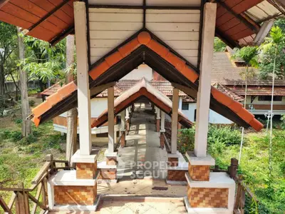 Charming rustic entrance with traditional architecture and lush greenery