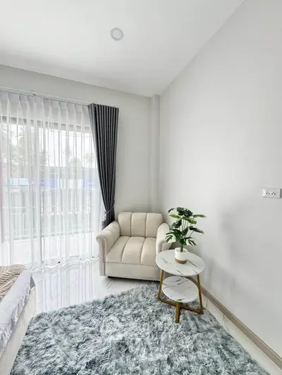 Cozy bedroom corner with plush armchair and stylish decor