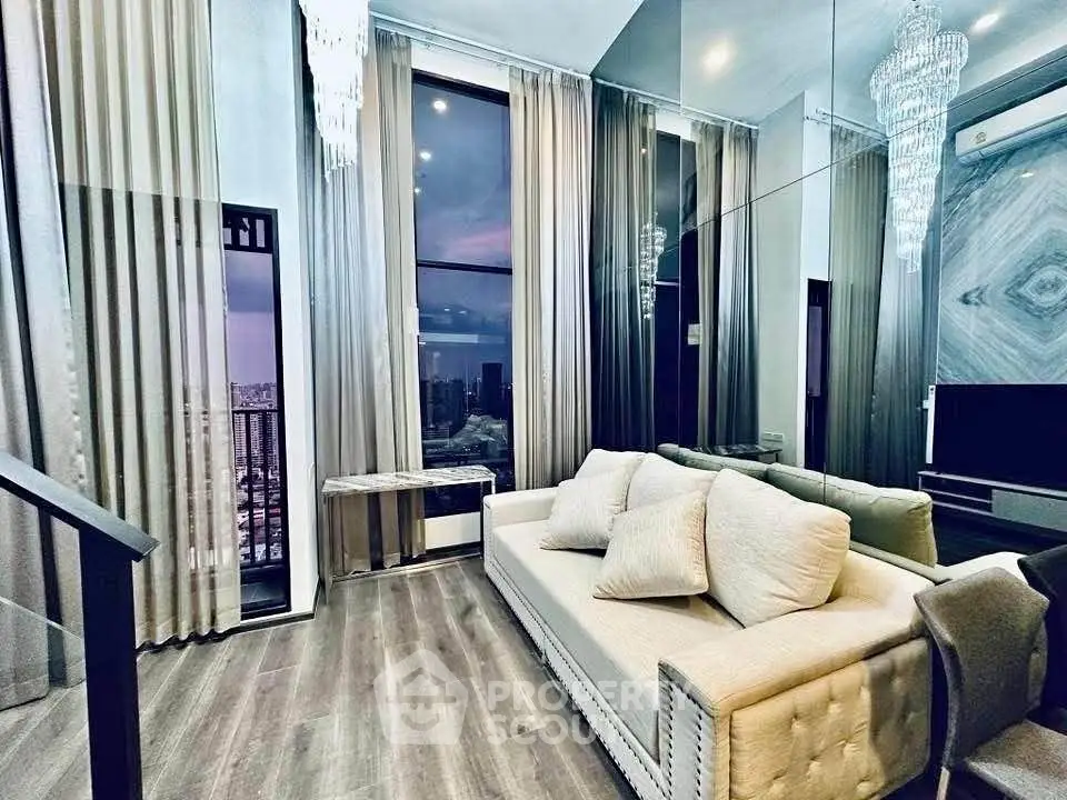 Luxurious living room with high ceilings, elegant chandelier, and stunning city view.