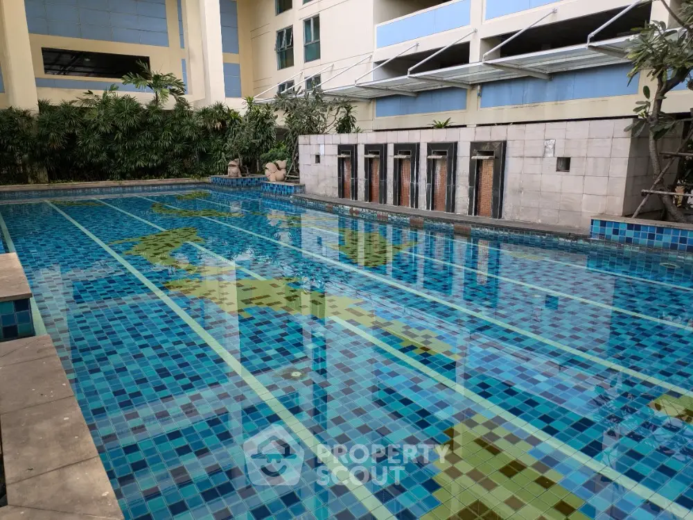 Luxurious residential swimming pool with modern design and vibrant blue tiles, perfect for relaxation and leisure.