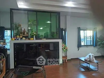 Spacious living room with modern decor and large windows for natural light.