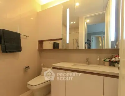 Modern bathroom with sleek fixtures and ample storage space.