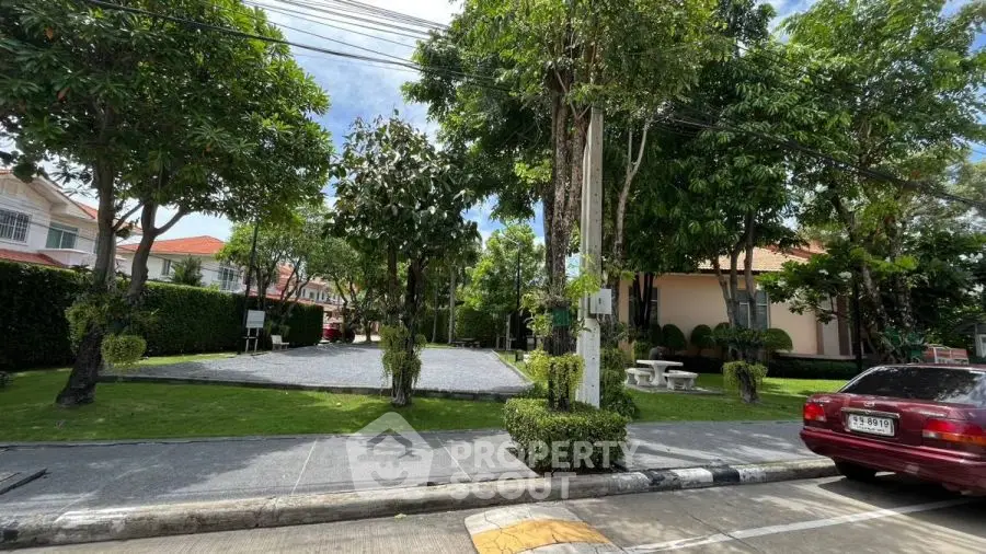 Charming residential neighborhood with lush greenery and well-maintained gardens.