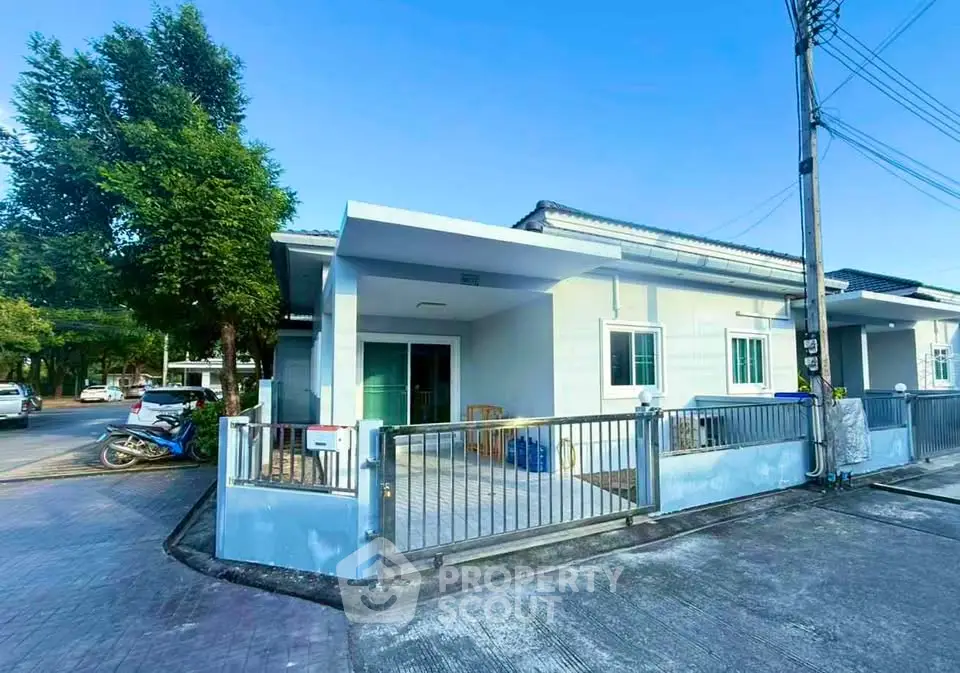 Charming single-story home with gated entrance and spacious driveway in a serene neighborhood.