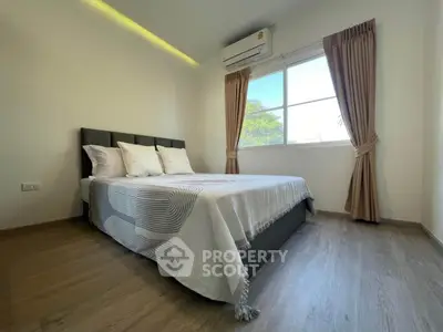 Modern bedroom with large window and stylish decor in a bright apartment