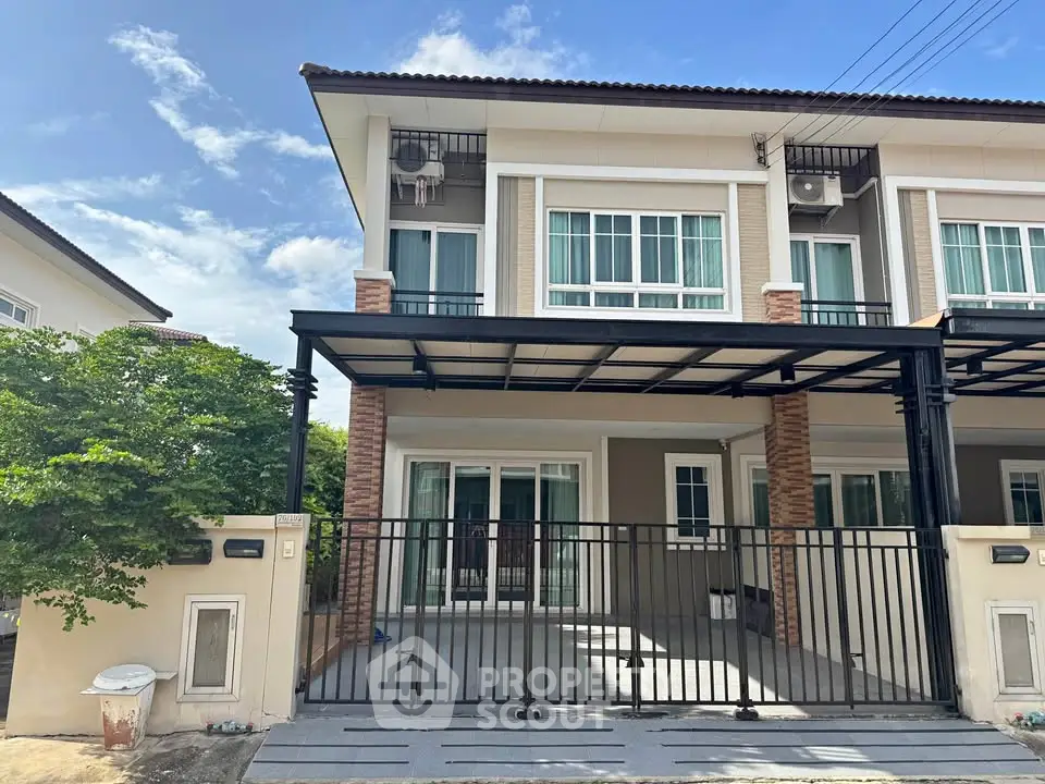 Modern two-story townhouse with gated entrance and covered parking in a serene neighborhood.