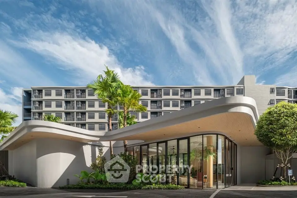 Modern building exterior with lush landscaping and unique architectural design.