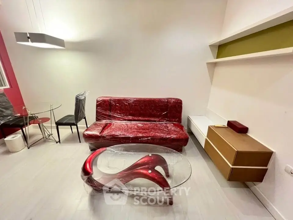 Modern living room with unique red furniture and sleek design elements