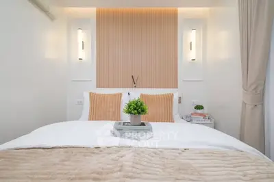 Cozy and modern bedroom with elegant lighting and plush bedding, perfect for relaxation.