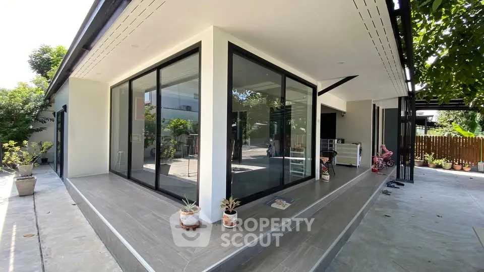 Modern corner unit with large glass windows and spacious patio area.