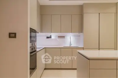 Modern kitchen with sleek cabinetry and built-in appliances in a minimalist design.