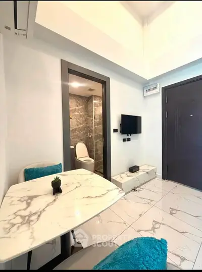 Modern apartment interior with marble dining table and compact living area