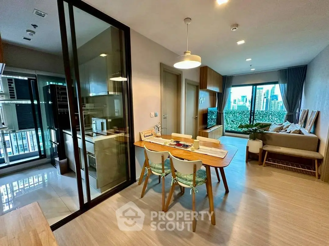 Modern open-plan living room with dining area and city view balcony