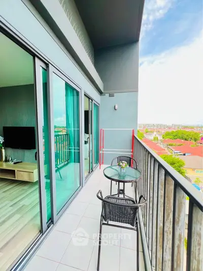 Modern balcony with glass doors and city view, perfect for relaxation and entertainment.