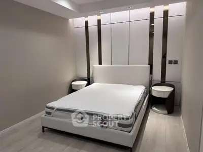 Modern bedroom with sleek design and stylish furniture, featuring a comfortable bed and elegant nightstands.