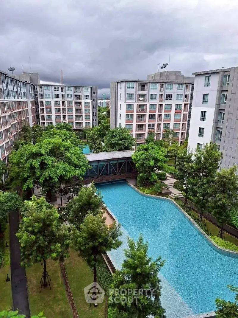 Luxurious residential complex with stunning pool and lush greenery