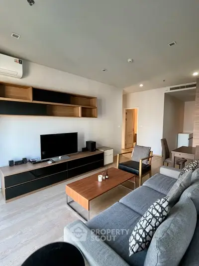 Modern living room with stylish furniture and entertainment center in a contemporary apartment.