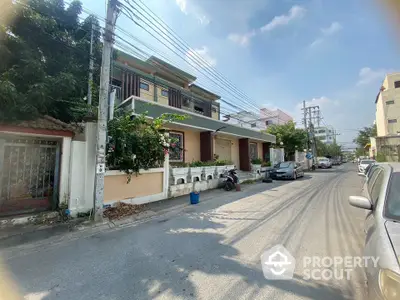 Charming residential street with modern houses and lush greenery