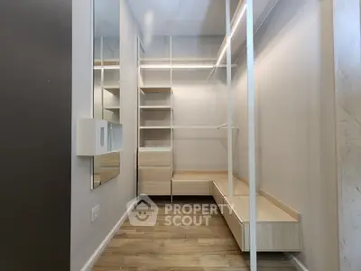 Spacious walk-in closet with modern shelving and wooden flooring