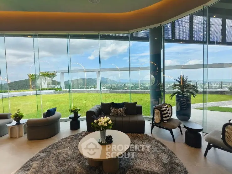 Luxurious living room with panoramic glass walls and stunning mountain view