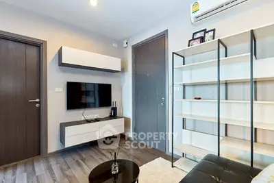 Modern living room with sleek furniture and wall-mounted TV in a stylish apartment.
