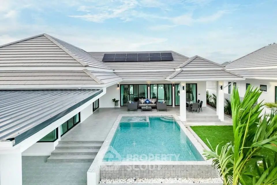 Luxurious modern villa with private pool and solar panels, perfect for sustainable living.