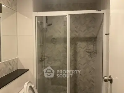 Modern bathroom with glass shower and stylish tile design