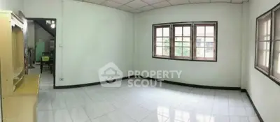 Spacious unfurnished room with large windows and tiled flooring, ideal for customization.