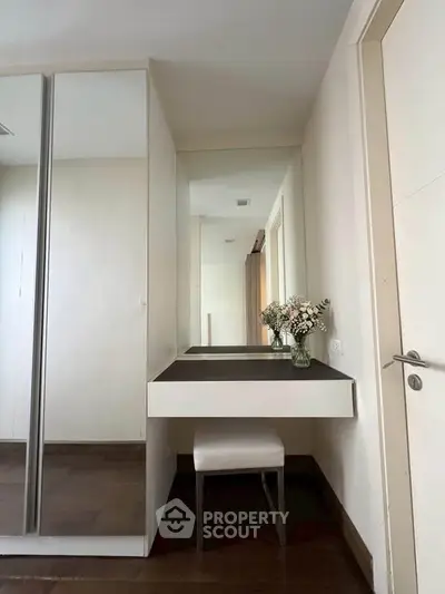 Elegant bedroom corner with mirrored wardrobe and stylish vanity desk