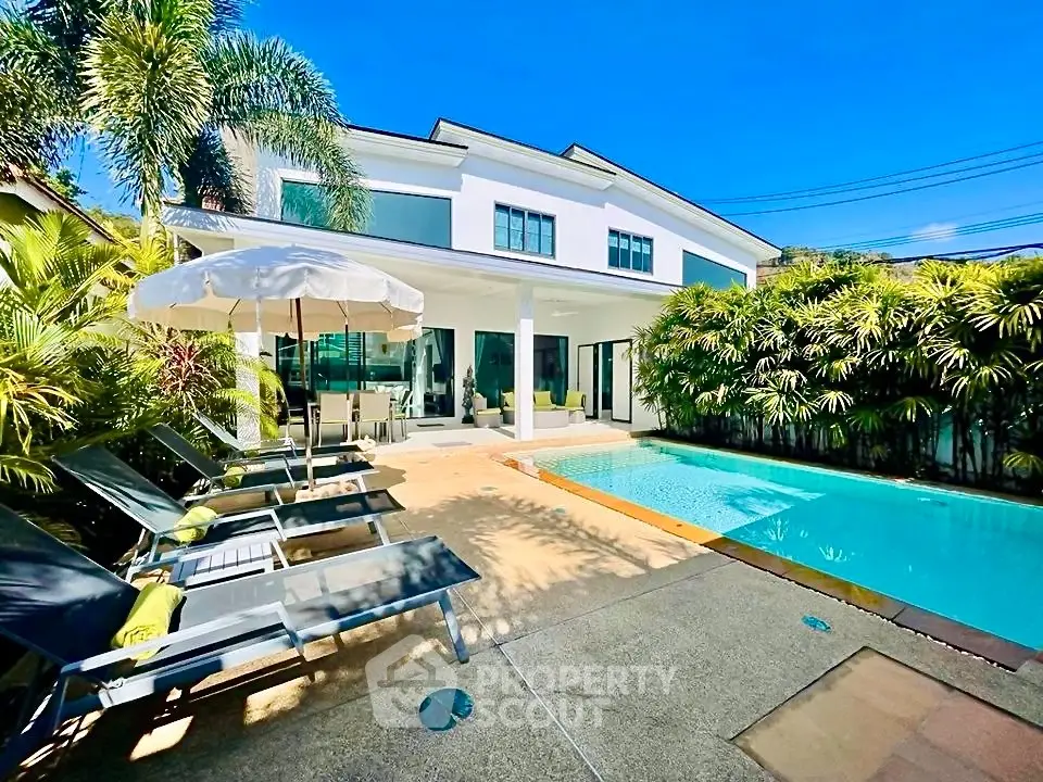 Luxurious modern villa with private pool and lush garden, perfect for relaxation and entertaining.