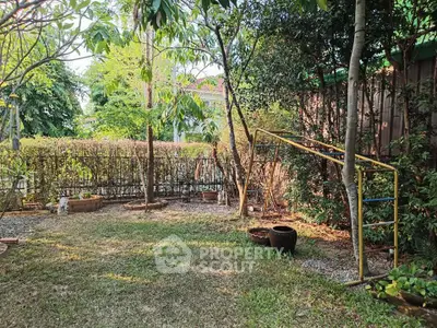 Charming garden with lush greenery and rustic elements, perfect for relaxation and outdoor activities.