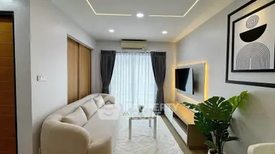 Modern living room with sleek design, featuring a cozy sofa, wall-mounted TV, and stylish decor.