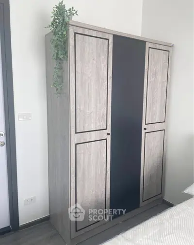 Modern bedroom with sleek wardrobe and minimalist decor