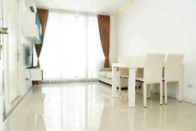 Bright and modern living room with sleek furniture and large windows in a contemporary apartment.