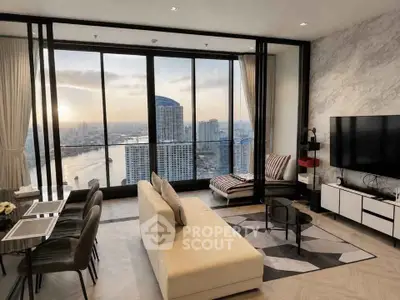 Luxurious living room with stunning city and river view, modern decor and floor-to-ceiling windows.