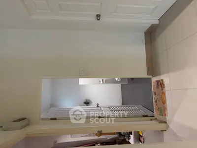 Modern bathroom entrance with white door and tiled flooring