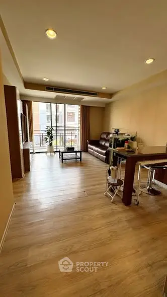 Spacious living room with modern decor and balcony access