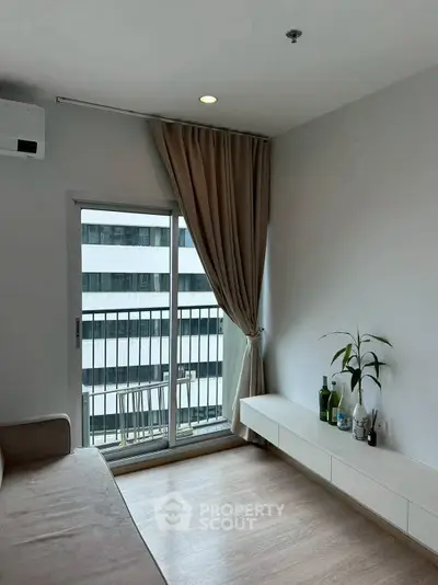 Modern living room with balcony view and minimalist decor