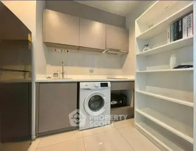 Modern kitchen with washing machine and sleek cabinetry