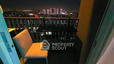 Stunning cityscape view from a cozy balcony at night, perfect for relaxation and enjoying the skyline.