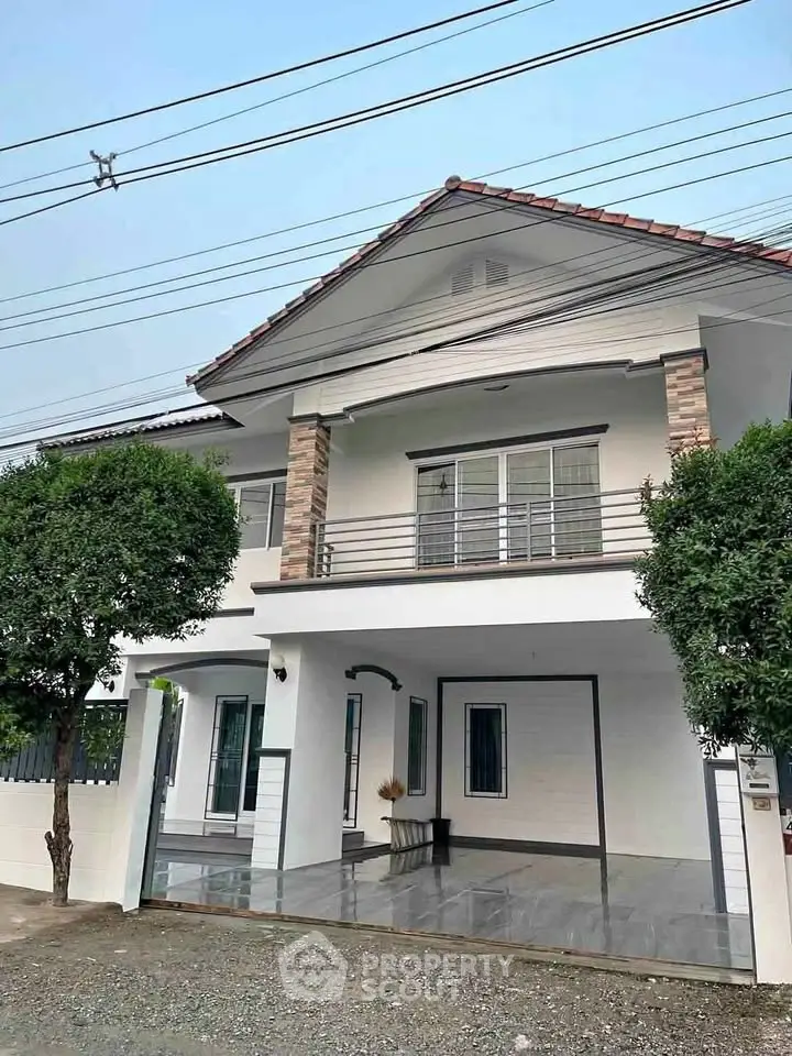 Charming two-story house with modern facade and spacious driveway, perfect for family living.