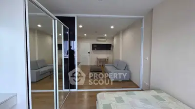 Modern studio apartment with mirrored wardrobe and cozy living area