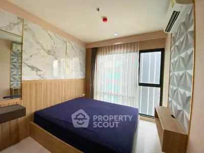 Modern bedroom with stylish decor and large window in a contemporary apartment.