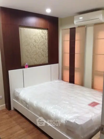 Modern bedroom with elegant wood paneling and air conditioning unit