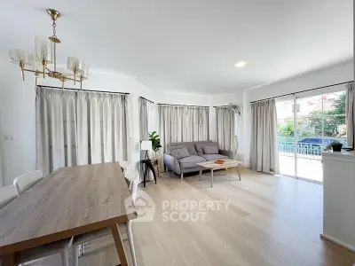 Spacious living room with modern decor and large windows for natural light.